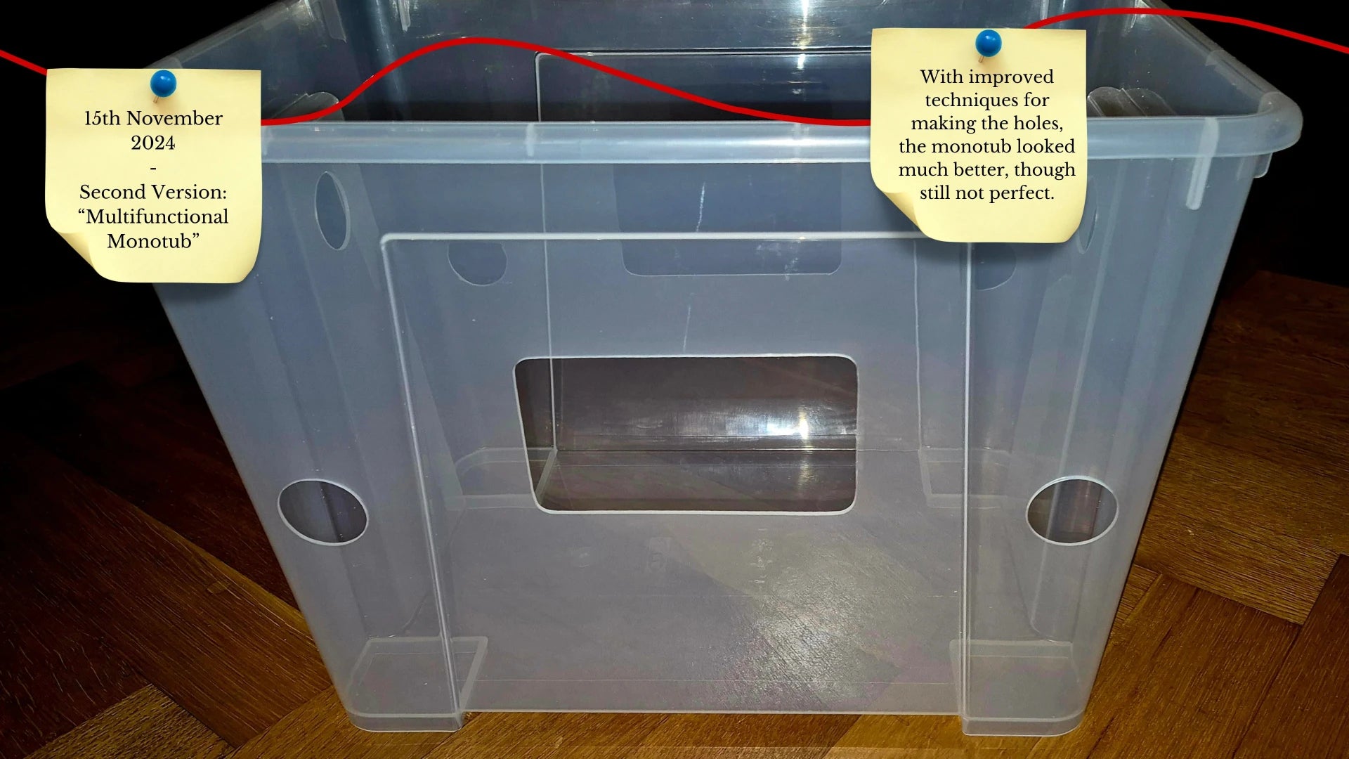 A clear plastic monotub showing significantly cleaner ventilation holes than the first version. A sticky note dated November 15, 2024, describes it as the second version with improved production techniques.