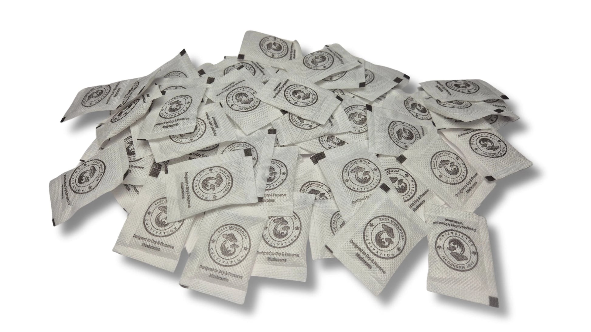 A large, scattered pile of white desiccant packets on a white surface. Every packet displays a circular logo of a mushroom and the brand name "Easy Mushroom Cultivation."