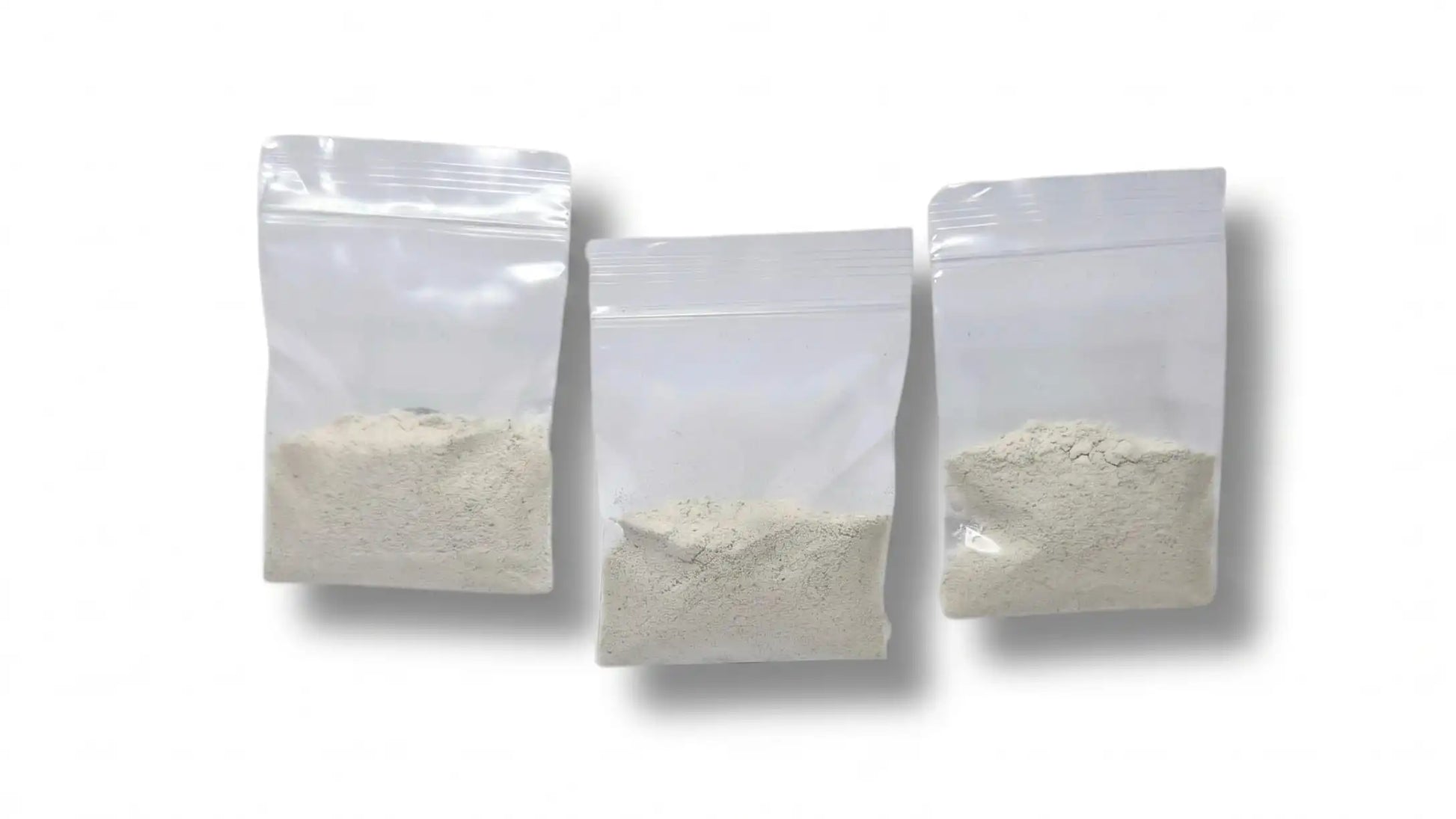 Three clear plastic ziploc bags filled with dry malt extract agar MEA powder.